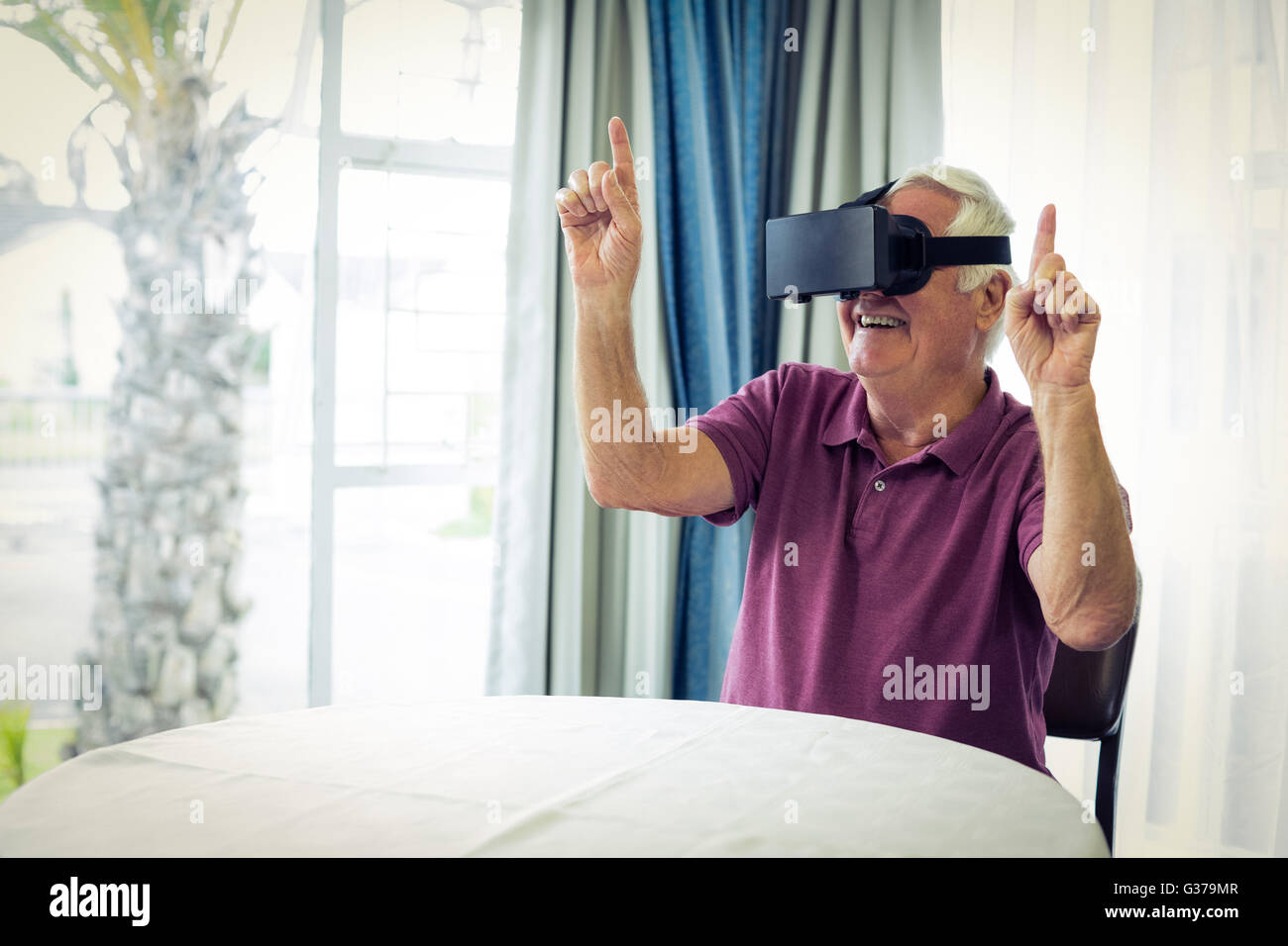 Senior man wearing virtual glasses Stock Photo