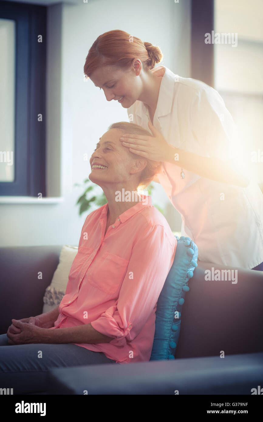 Female nurse giving head massage to woman Stock Photo - Alamy