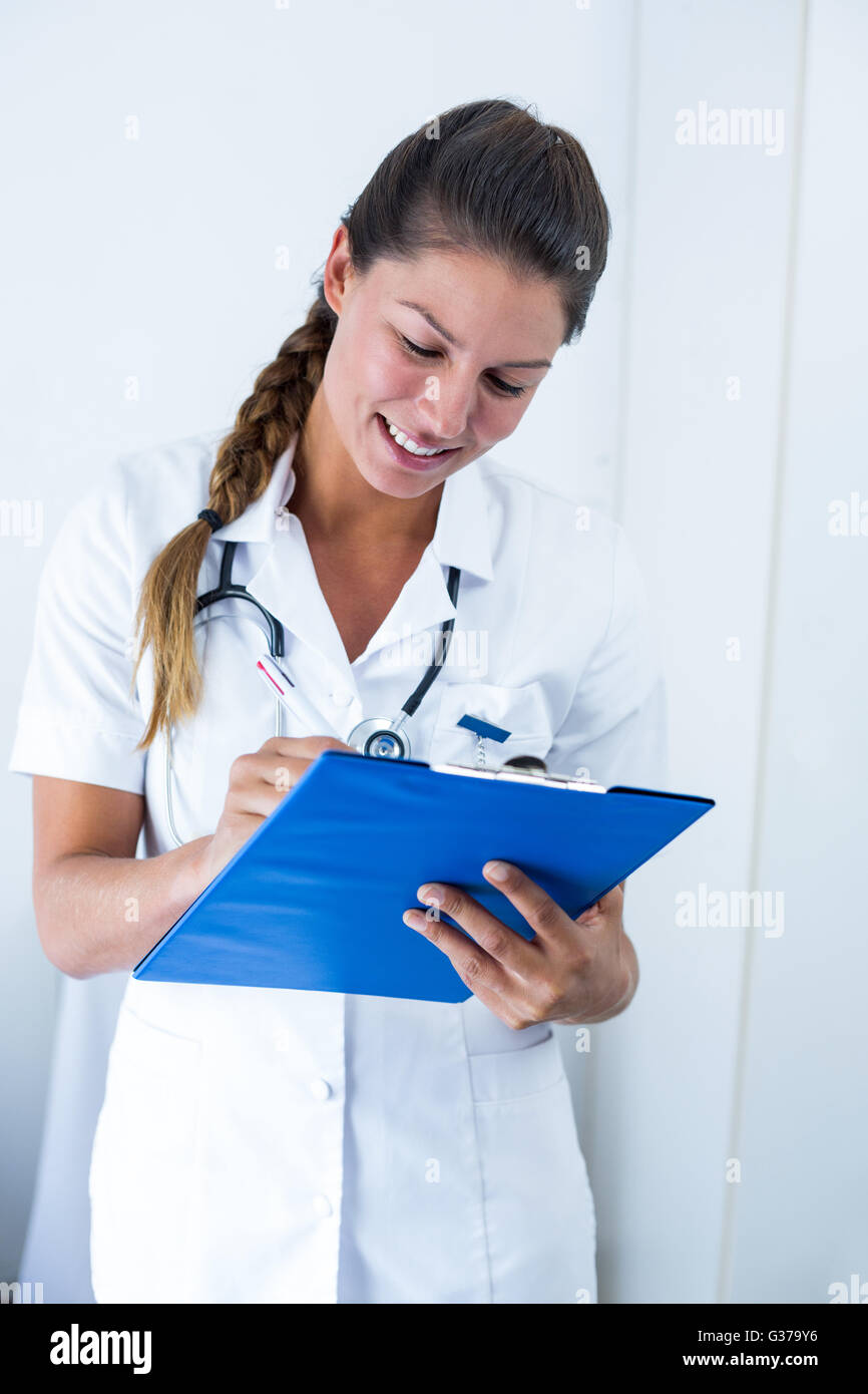 Female doctor writing clipboard hi-res stock photography and images - Alamy