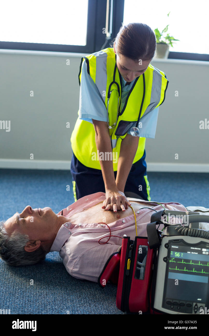 Paramedic using an external defibrillator during cardiopulmonary resuscitation Stock Photo