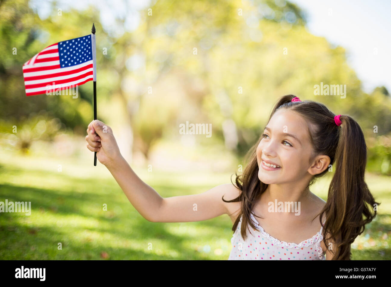 Girl holding an American flag Stock Photo - Alamy