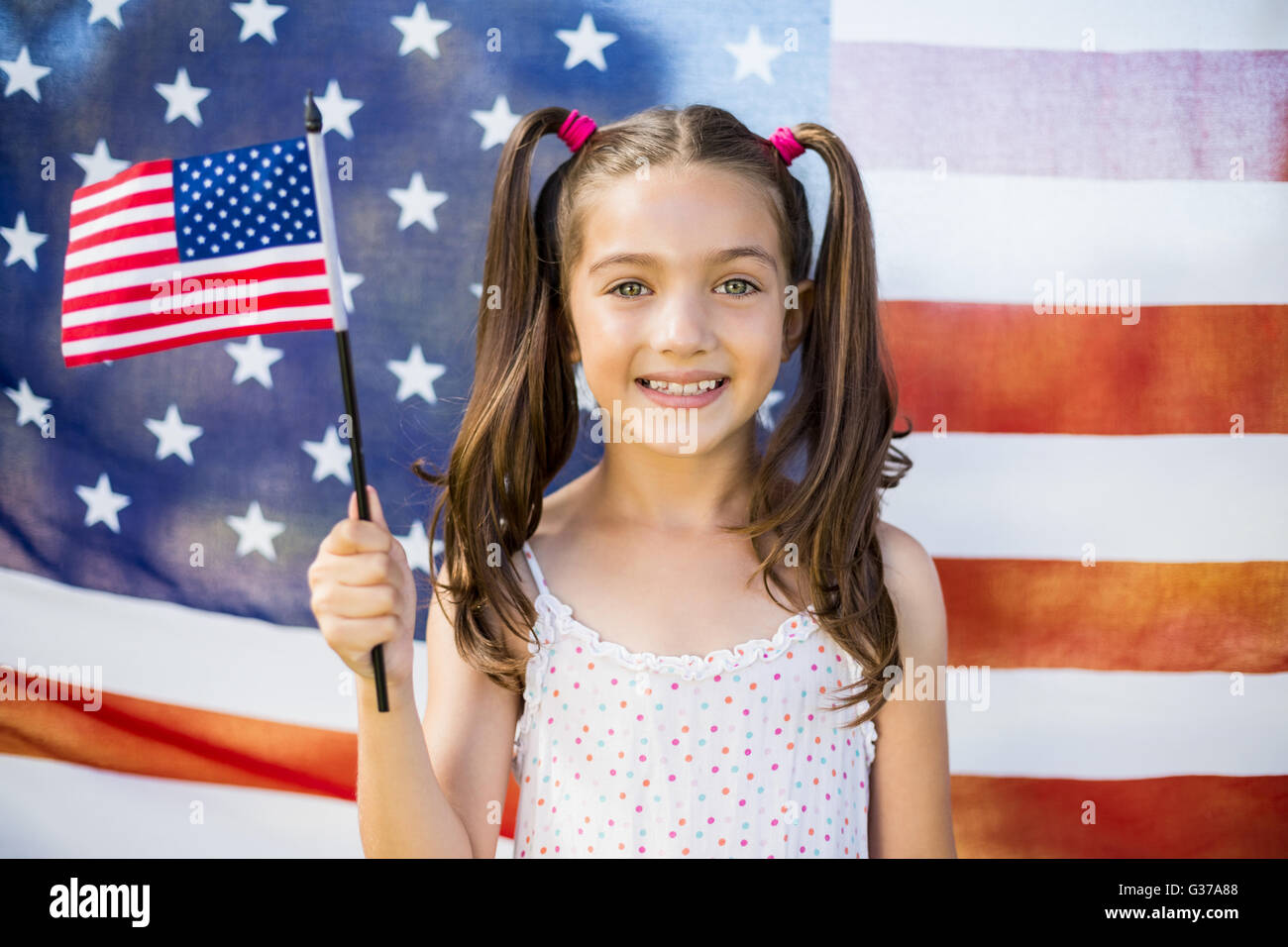 Young girl holding American flag Stock Photo - Alamy