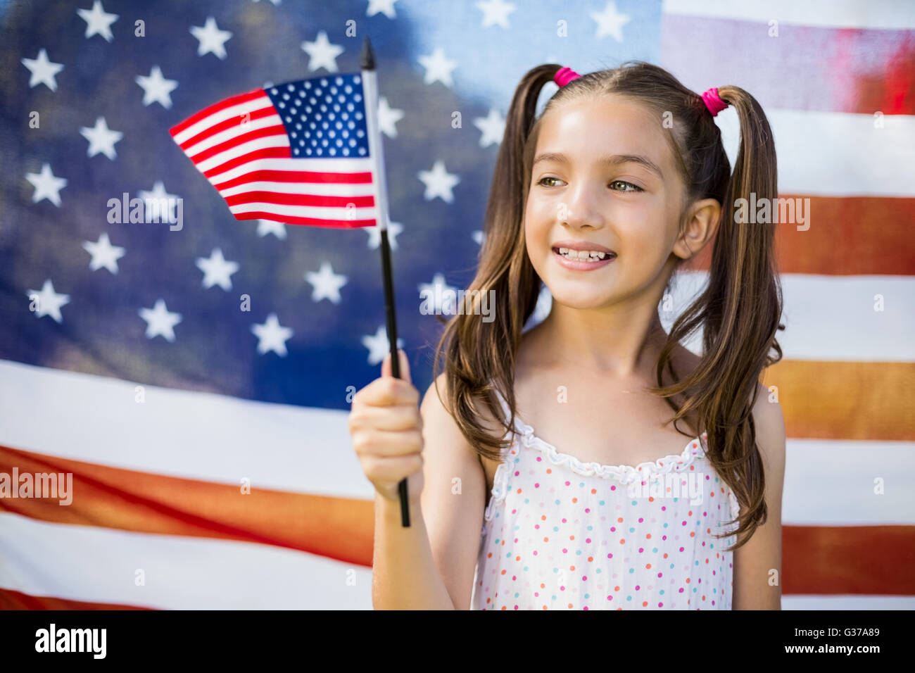 Young girl holding American flag Stock Photo - Alamy