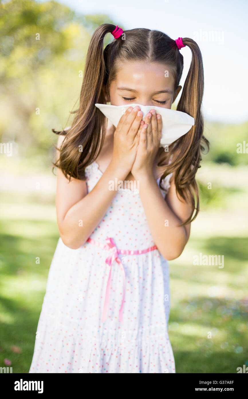 Girl blowing her nose with handkerchief while sneezing Stock Photo Alamy
