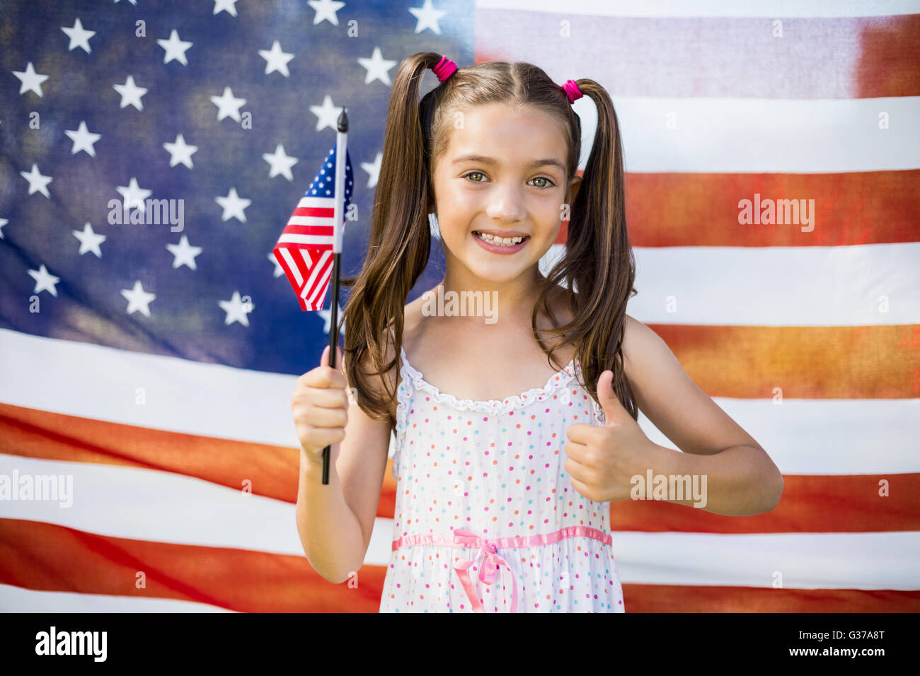 Young girl holding American flag Stock Photo - Alamy