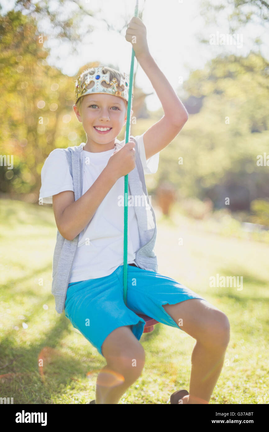 Boy swinging on swing Stock Photo
