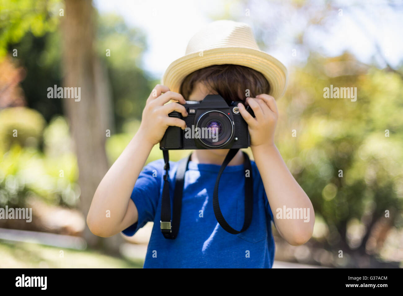 Young boy clicking a photograph from camera Stock Photo