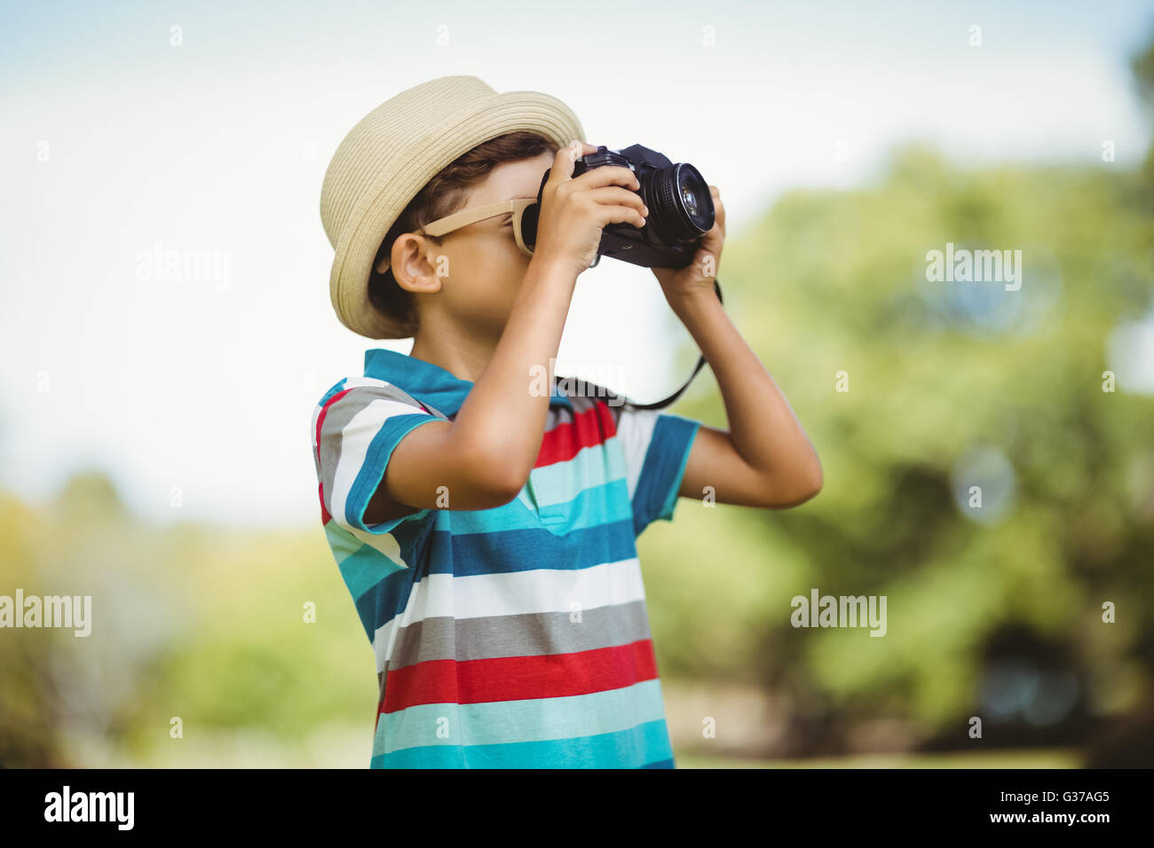 Young boy clicking a photograph from camera Stock Photo