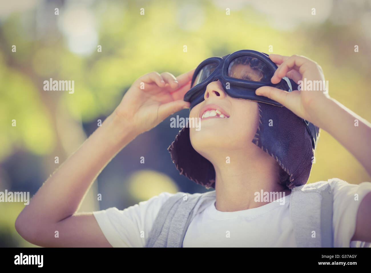 Boy in aviator goggles looking up Stock Photo
