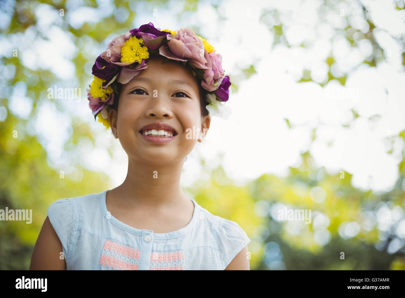 Girl smiling in park alone Stock Photo