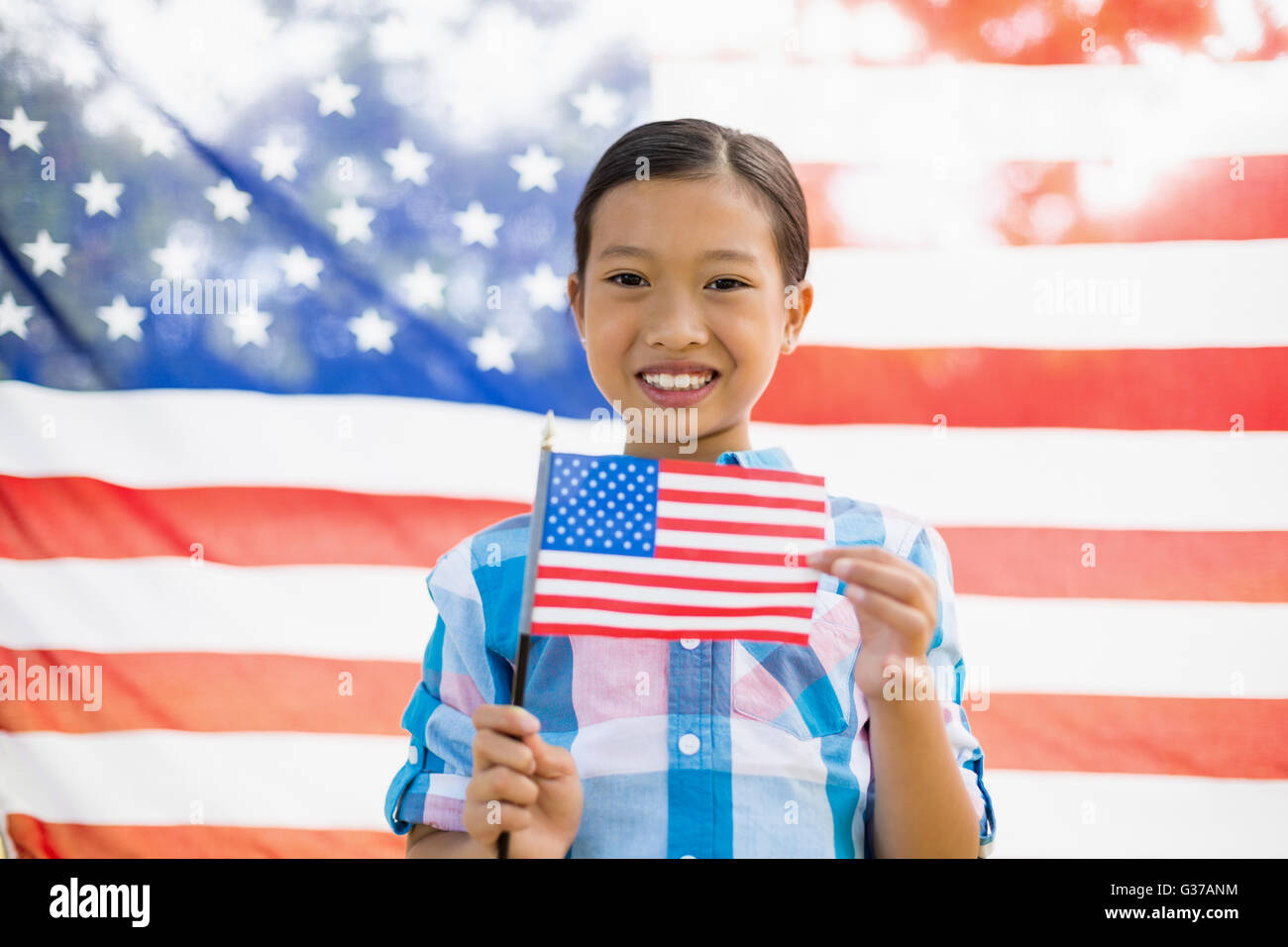 Young girl holding American flag Stock Photo - Alamy