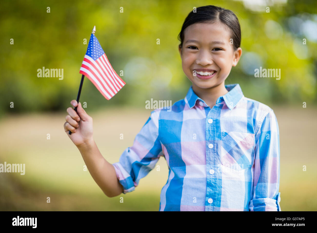 Girl holding an American flag Stock Photo - Alamy