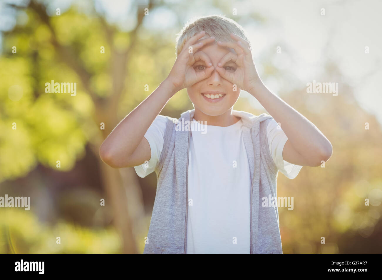 Portrait of young boy smiling in park Stock Photo - Alamy