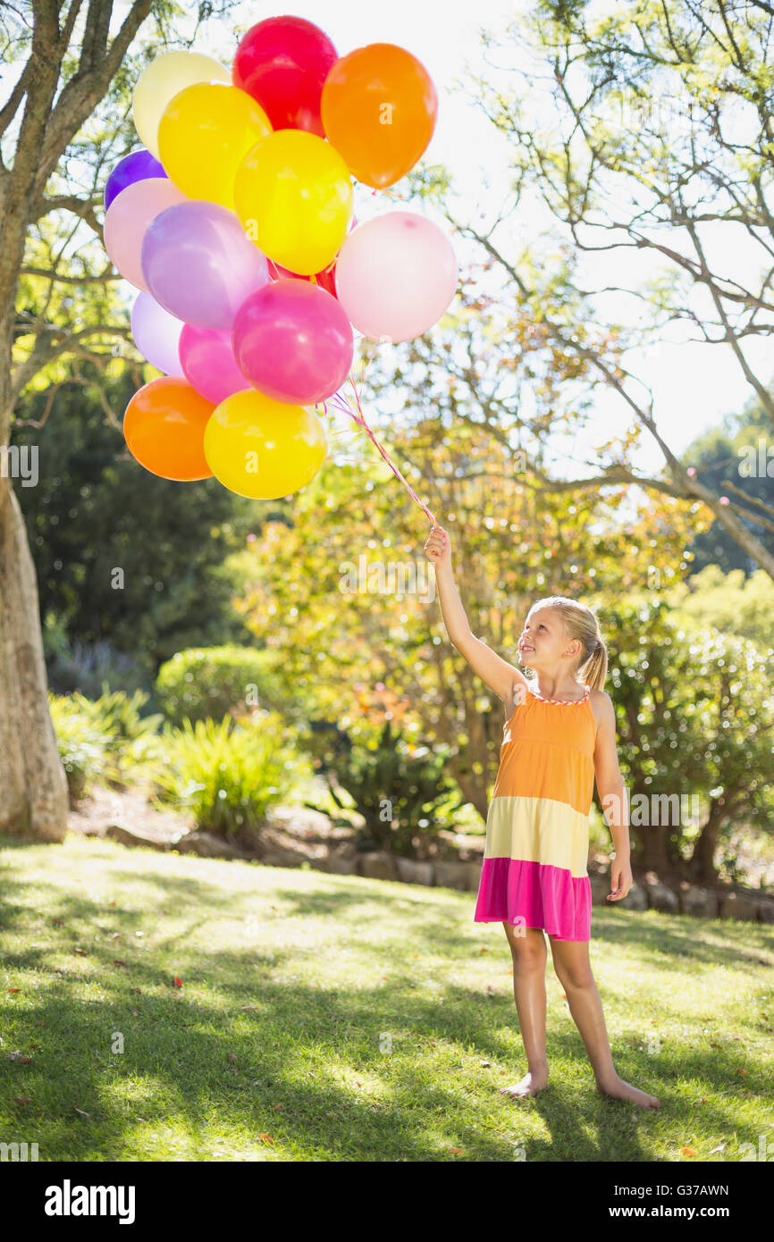 Girl holding balloons hi-res stock photography and images - Alamy
