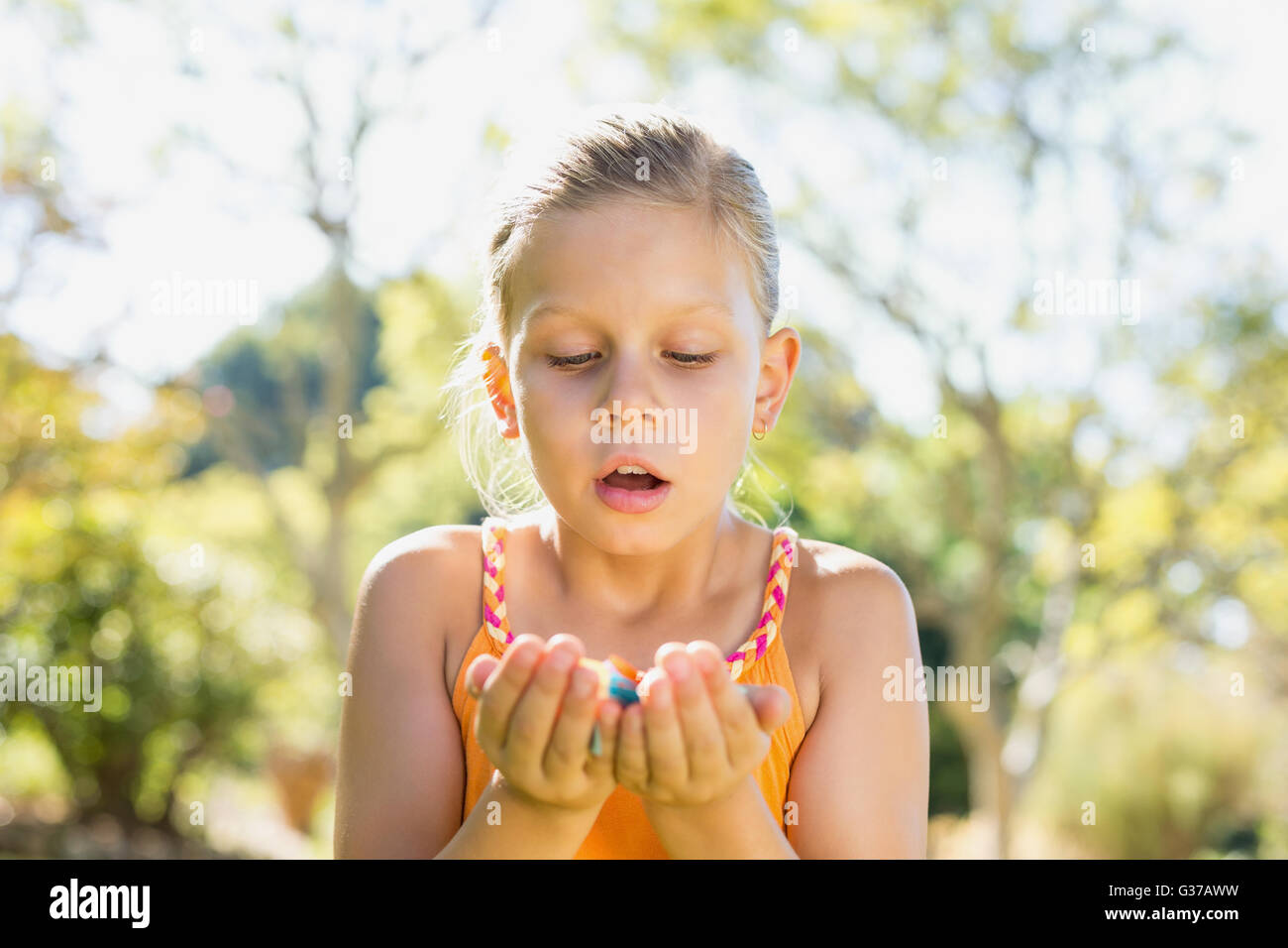 Girl holding petals in park Stock Photo Alamy