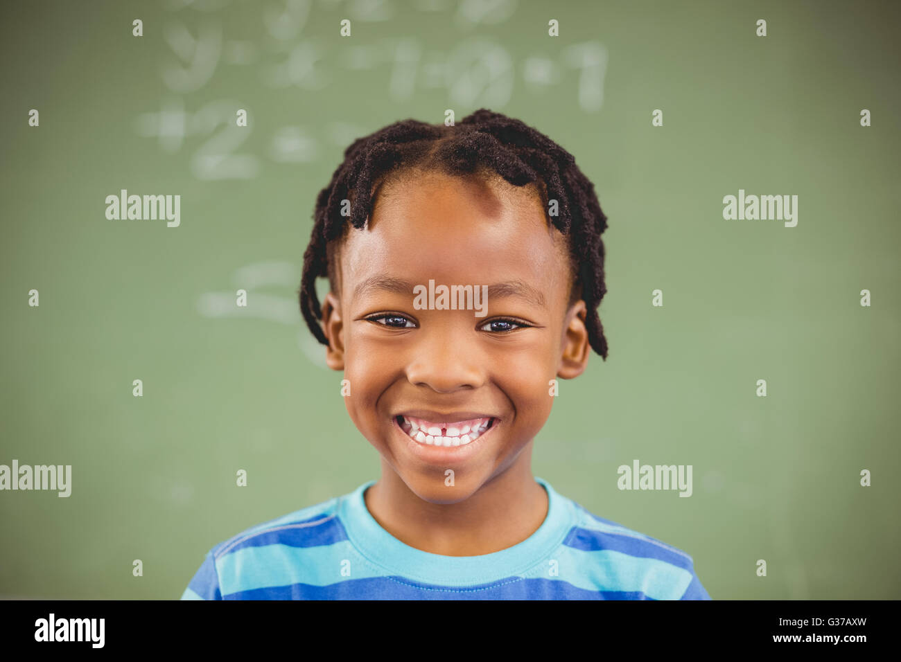 Portrait of happy schoolboy smiling in classroom Stock Photo - Alamy