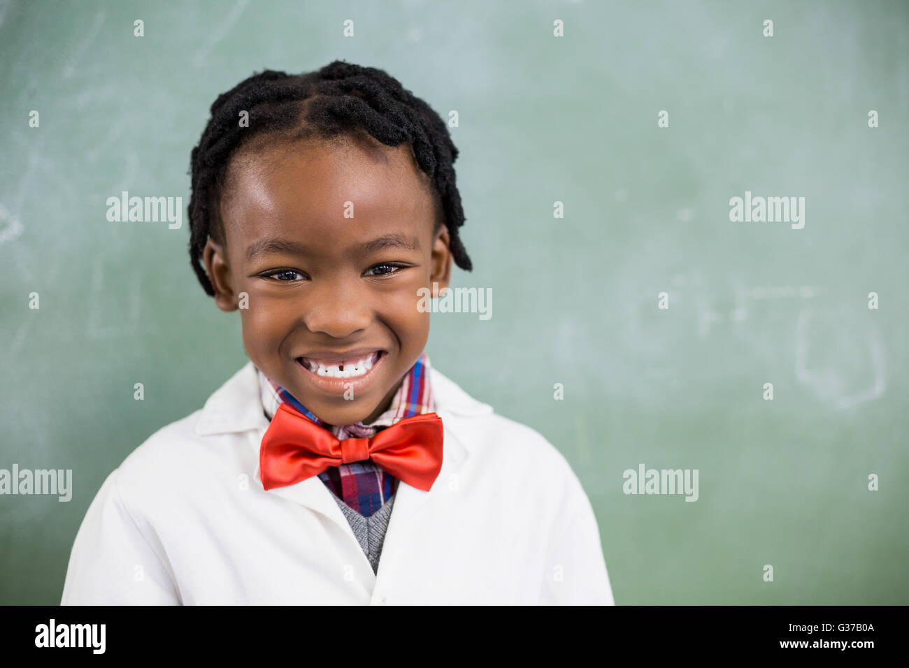 Portrait of happy schoolboy smiling in classroom Stock Photo - Alamy
