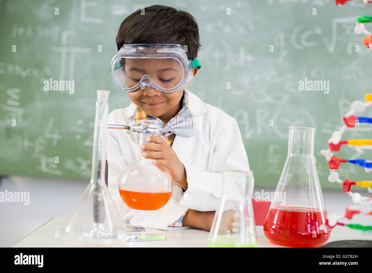 Schoolboy doing a chemical experiment in laboratory Stock Photo - Alamy
