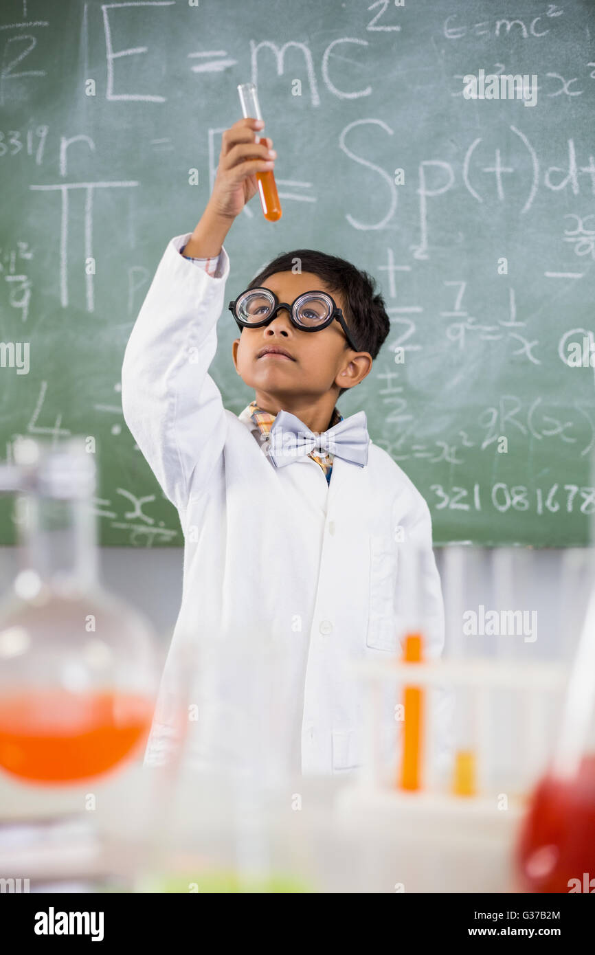 Schoolboy doing a chemical experiment in laboratory Stock Photo - Alamy