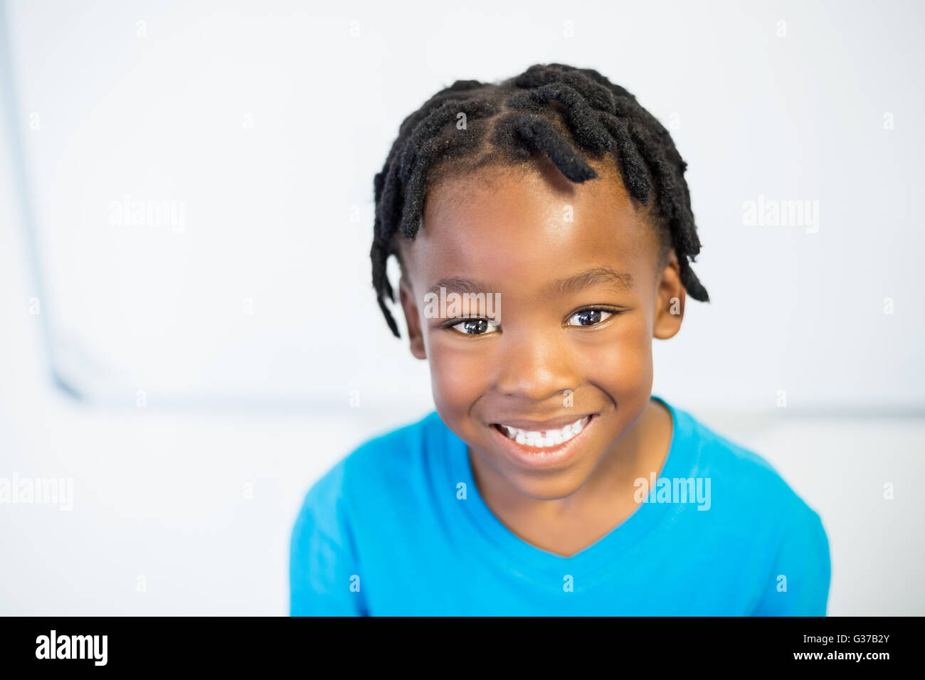 Portrait of smiling schoolboy in classroom Stock Photo - Alamy