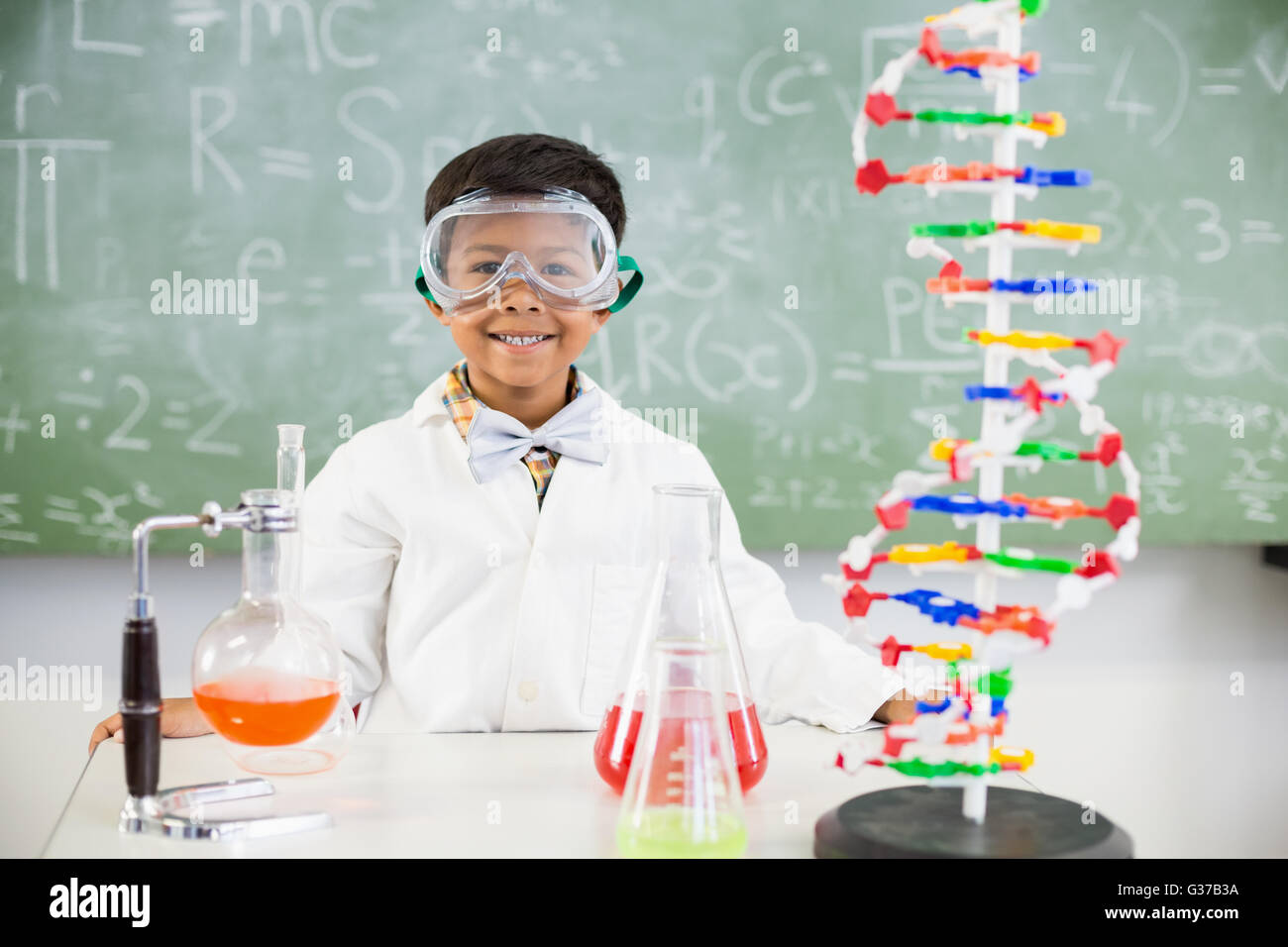 Portrait of schoolboy doing a chemical experiment in laboratory Stock ...