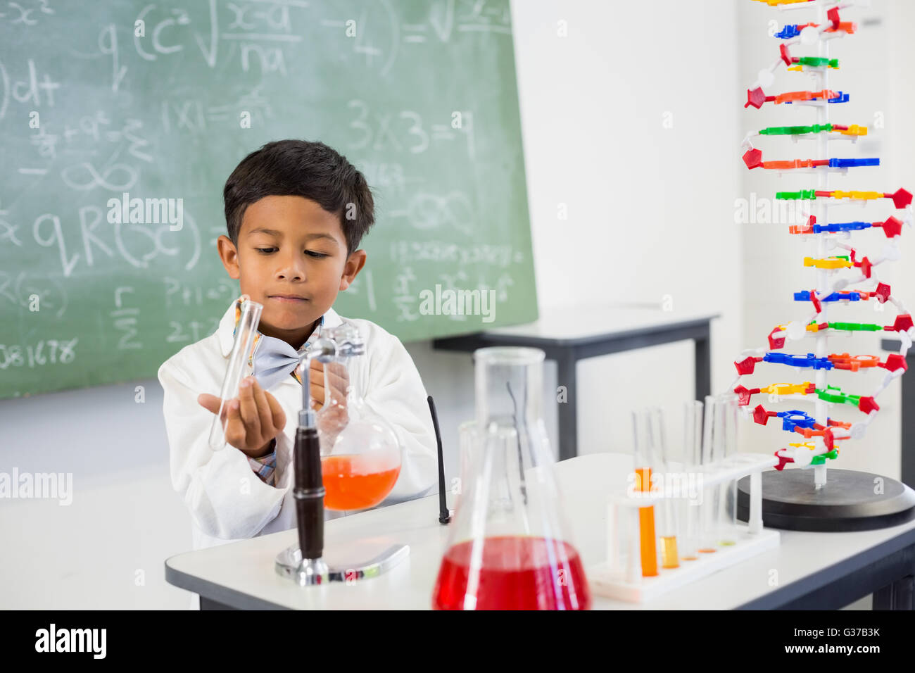 Schoolboy doing a chemical experiment in laboratory Stock Photo - Alamy