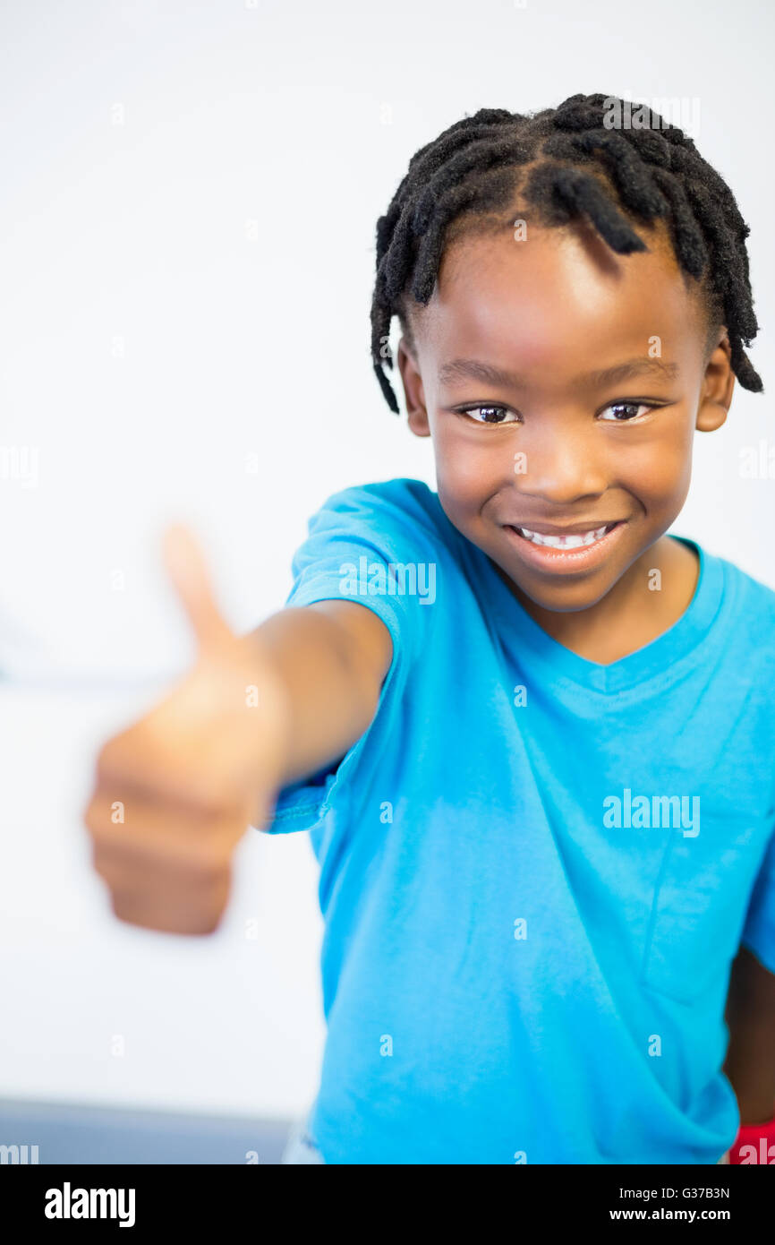 Portrait of smiling schoolboy showing thumbs Stock Photo - Alamy