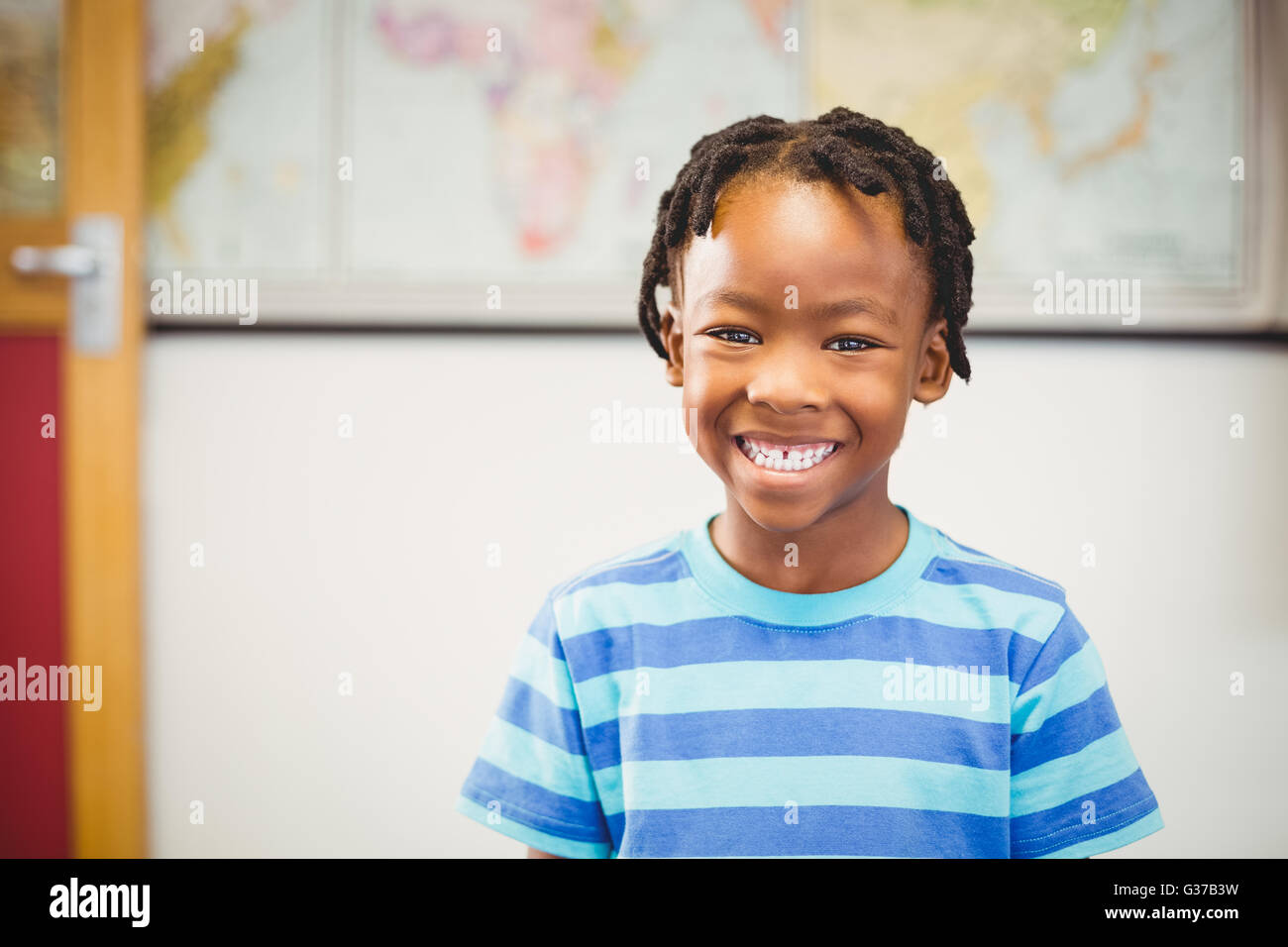 Portrait of smiling schoolboy in classroom Stock Photo - Alamy