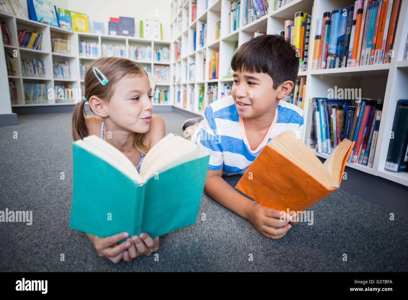 Girl lying on library floor hi-res stock photography and images - Alamy