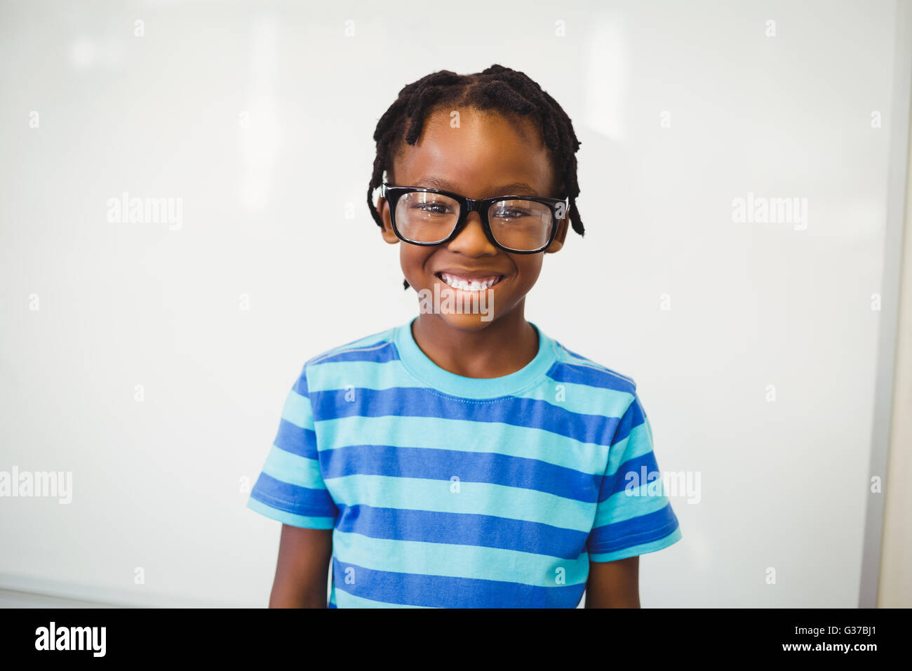 Portrait of happy schoolboy smiling in classroom Stock Photo - Alamy