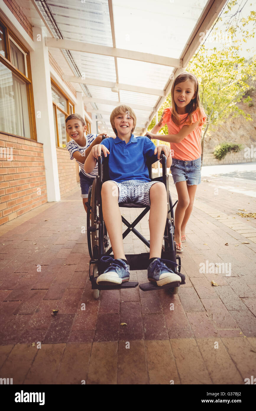 School kids pushing a boy on wheelchair Stock Photo - Alamy