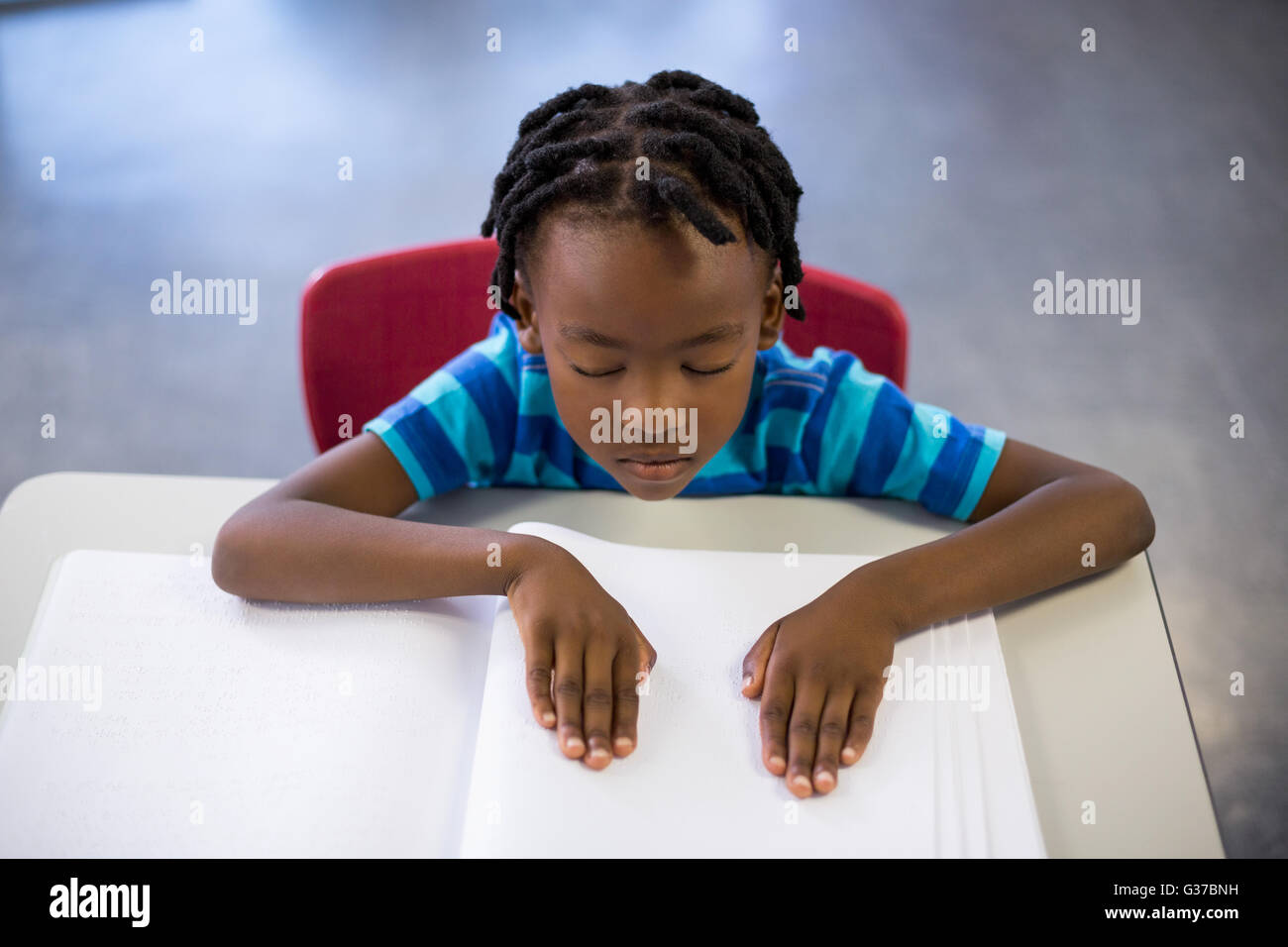 School boy memorizing the lesson in classroom Stock Photo