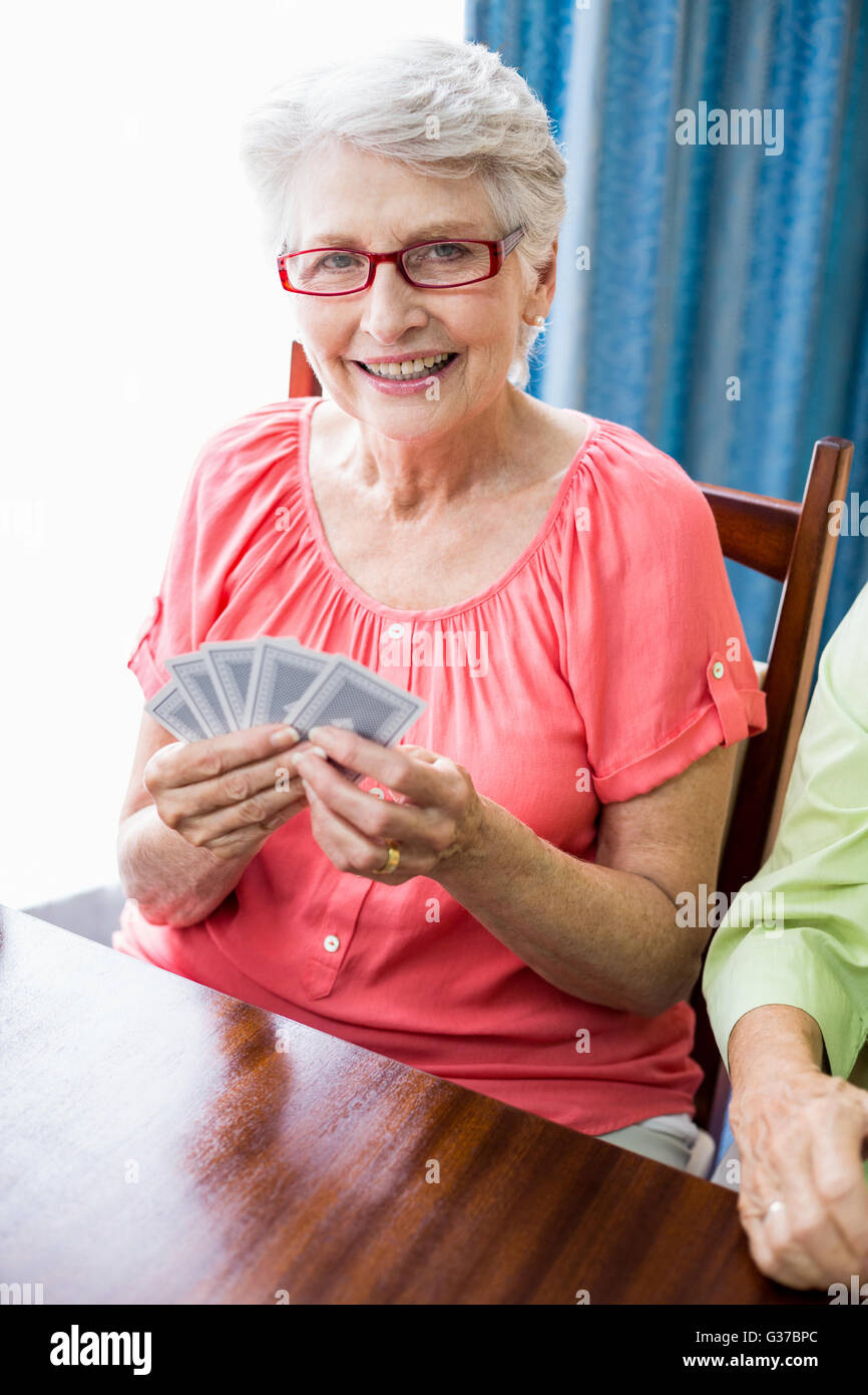Senior woman playing cards Stock Photo