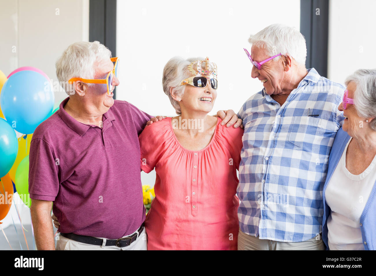 Seniors wearing funny glasses Stock Photo