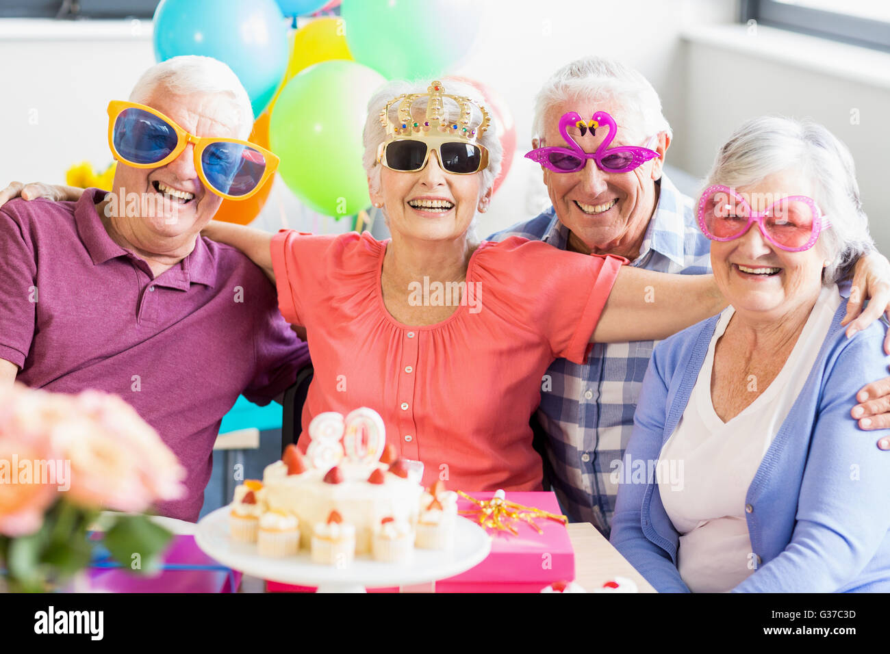 Seniors wearing funny glasses Stock Photo