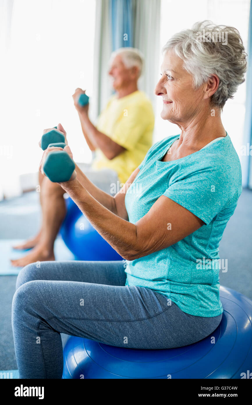 Seniors using exercise ball and weights Stock Photo Alamy