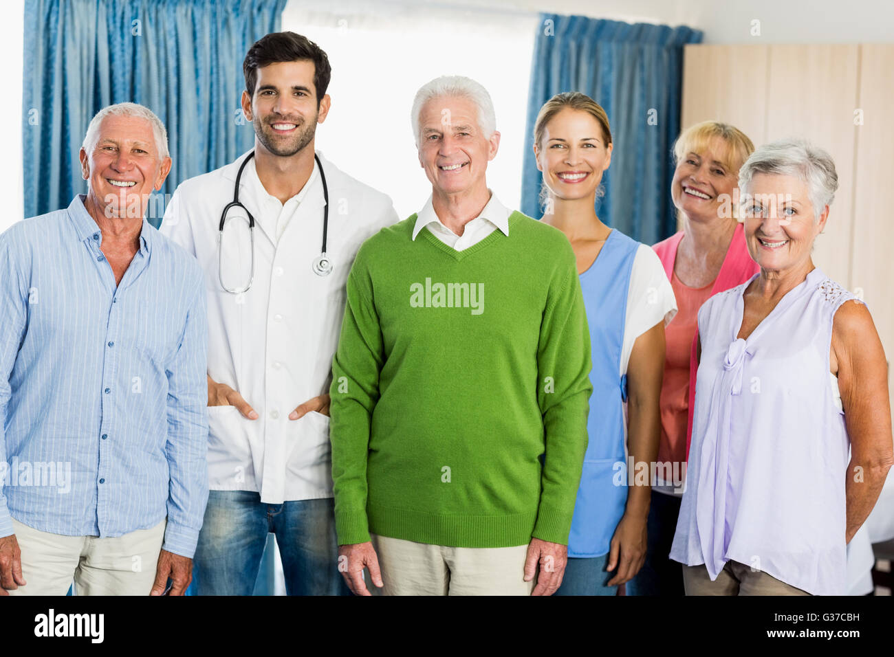 Nurse and seniors standing together Stock Photo