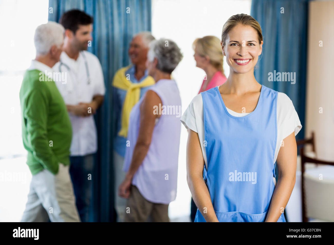 Nurse standing in front of seniors Stock Photo