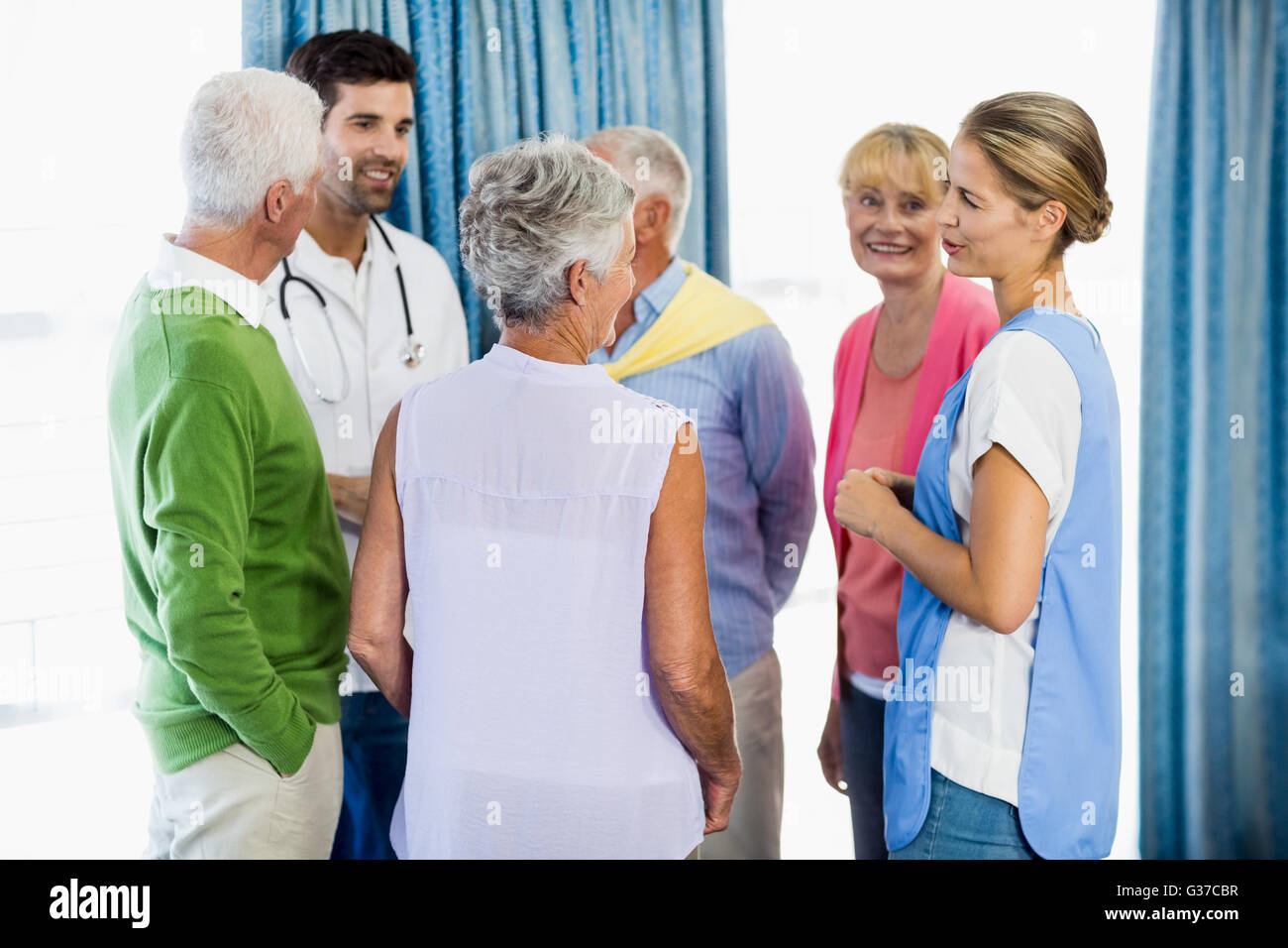 Nurses talking with seniors Stock Photo