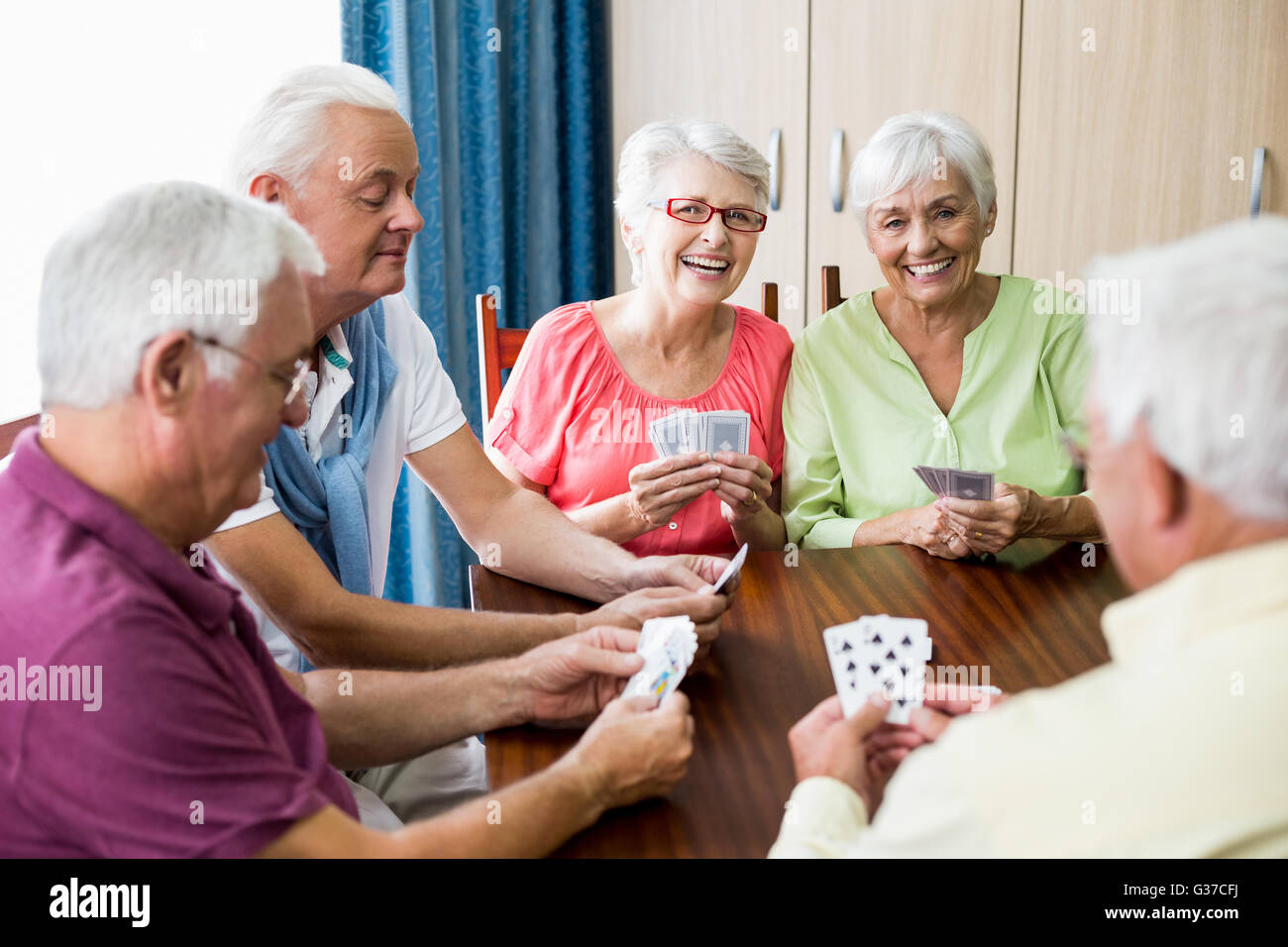 Seniors playing cards together Stock Photo