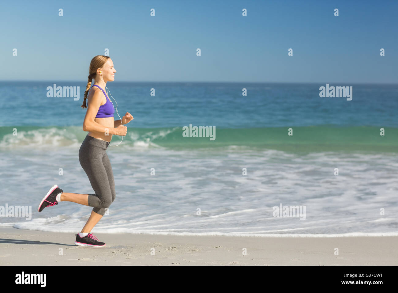 Woman listening music while exercising Stock Photo - Alamy