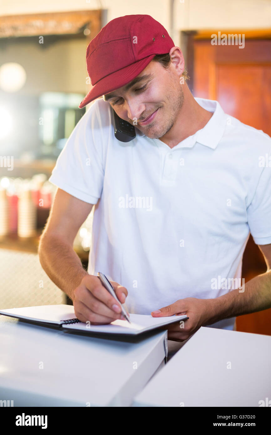 Pizza delivery man taking an order over the phone Stock Photo Alamy