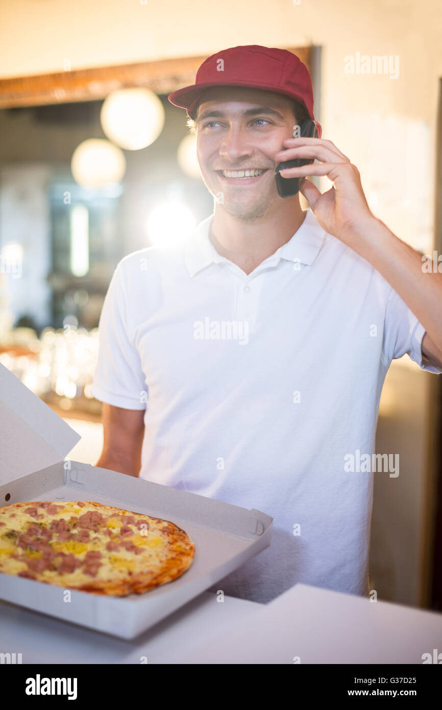 Pizza delivery man taking an order over the phone Stock Photo Alamy