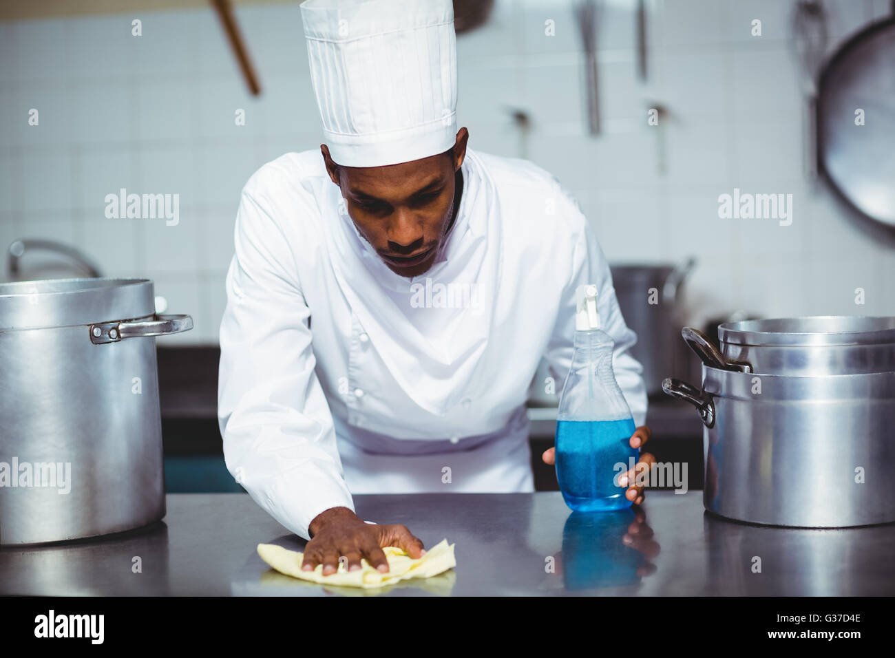 Chef cleaning kitchen counter Stock Photo