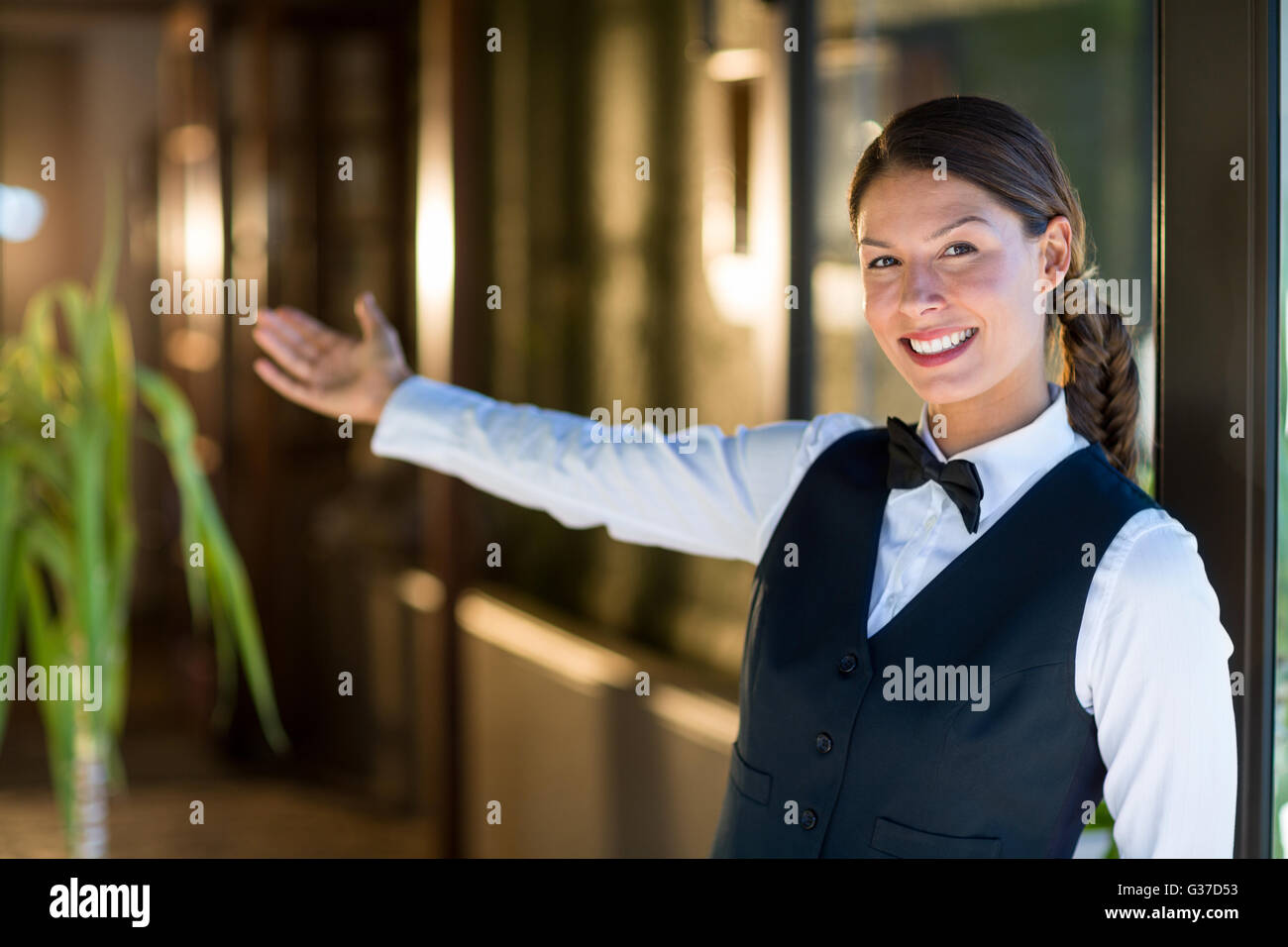 Portrait of smiling waitress welcoming Stock Photo