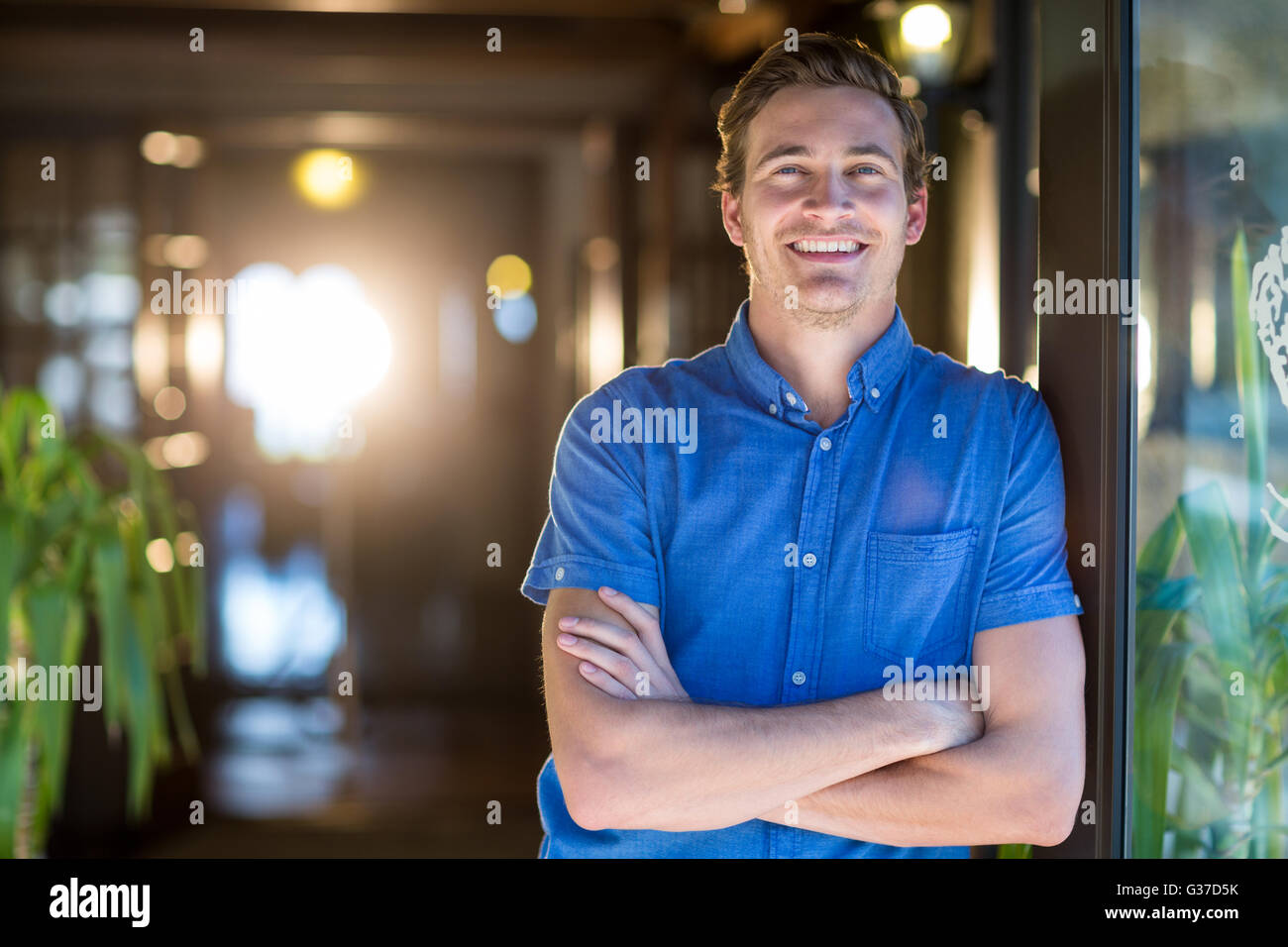 Portrait of smiling man standing with arms crossed Stock Photo - Alamy