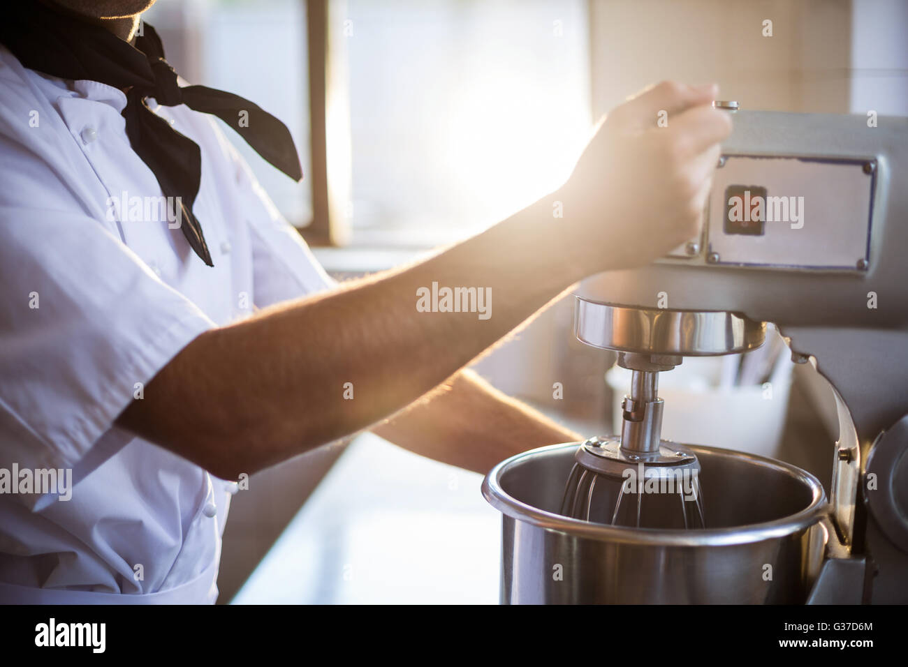 Mid section of chef blending the batter in mixing blender Stock Photo