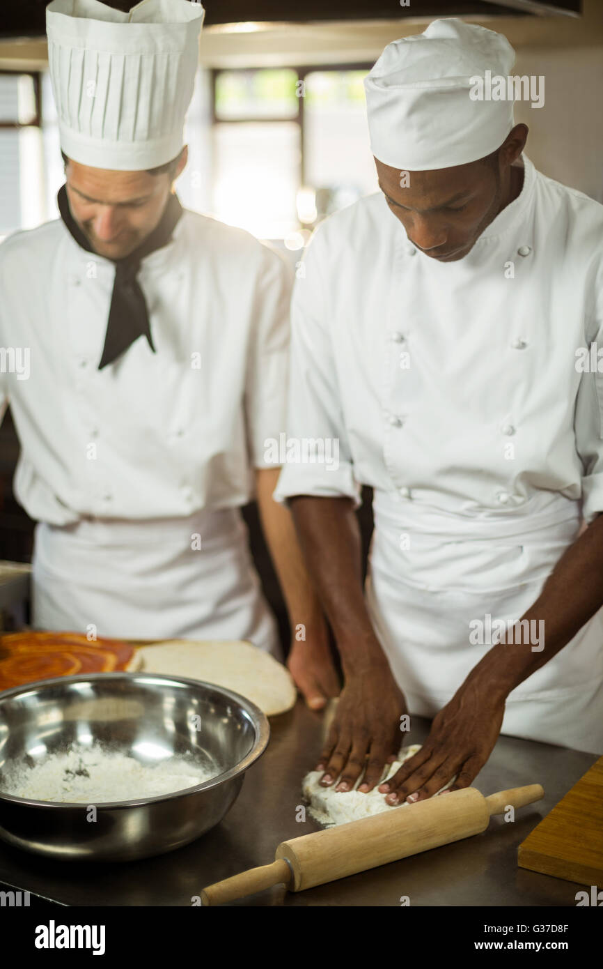 Two chefs making pizza doug Stock Photo