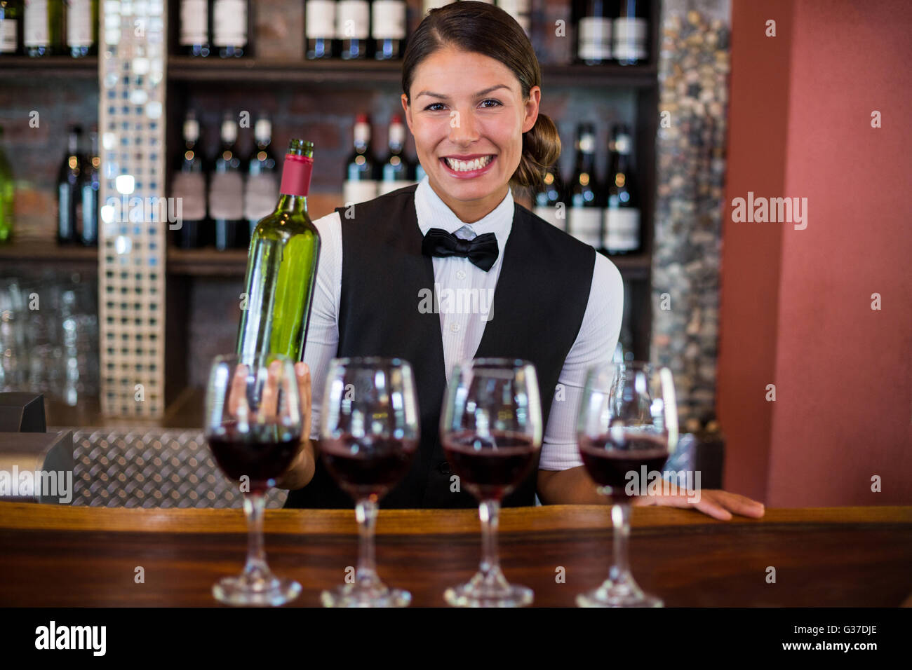 Four glasses of red wine ready to serve on bar counter Stock Photo Alamy
