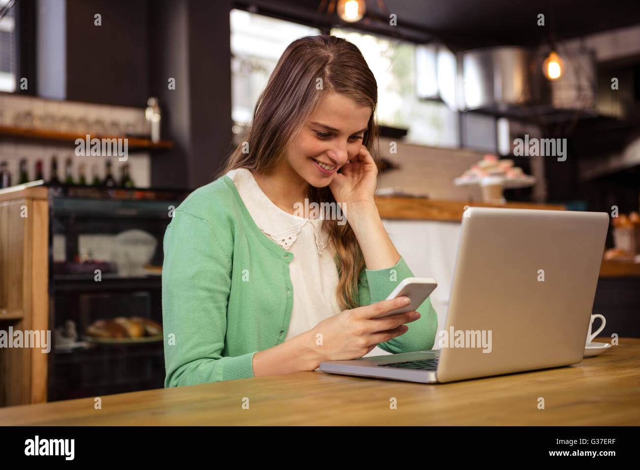 Normal Woman Using Tech Woman sitting using smartphone plants hi-res stock photography and ...